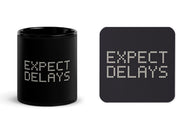 Expect Delays matching set with one black 11 oz mug and one cork-back coaster