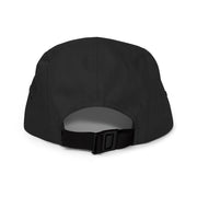 Black five-panel cap, rear view showing adjustable nylon strap and clip